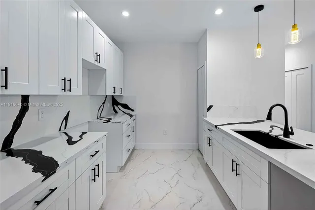 a kitchen with a sink a stove and cabinets