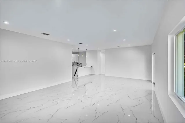 a bathroom with a granite countertop mirror a toilet and a shower