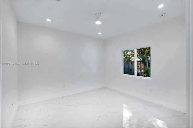 an empty room with windows and closet