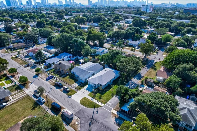 an aerial view of a house with garden space and street view