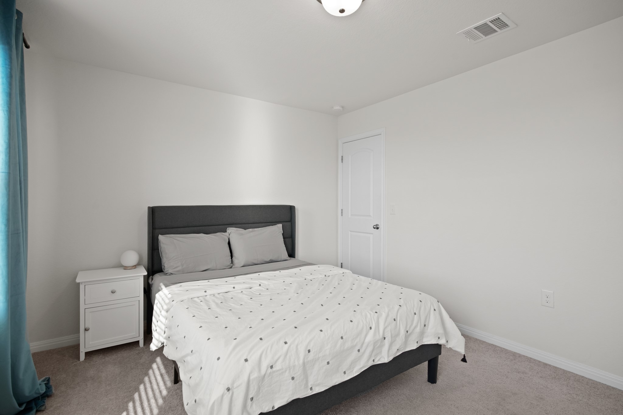 13005 Foreston Drive Austin, TX 78754 - Photo 23 of 36 a bedroom with a bed and a lamp
