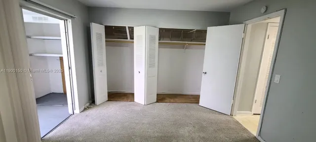 a view of hallway with closet area