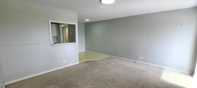 an empty room with mirror in it