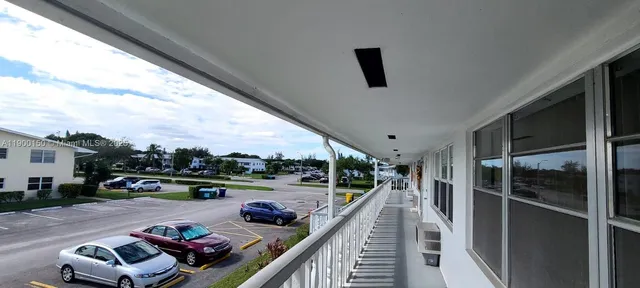 a view of a hall with stairs and a furniture