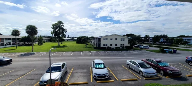 a view of a swimming pool with a dining table and chairs