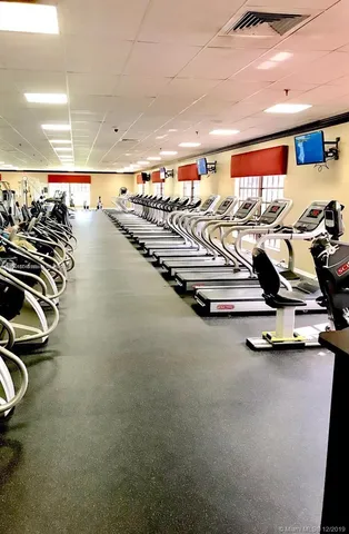 a view of a swimming pool with a yard and mountain in the back
