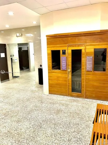 a view of a house with a swimming pool and sitting area