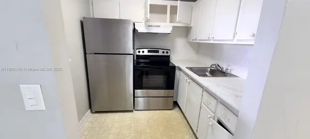 a kitchen with stainless steel appliances granite countertop white refrigerator stove a sink and dishwasher