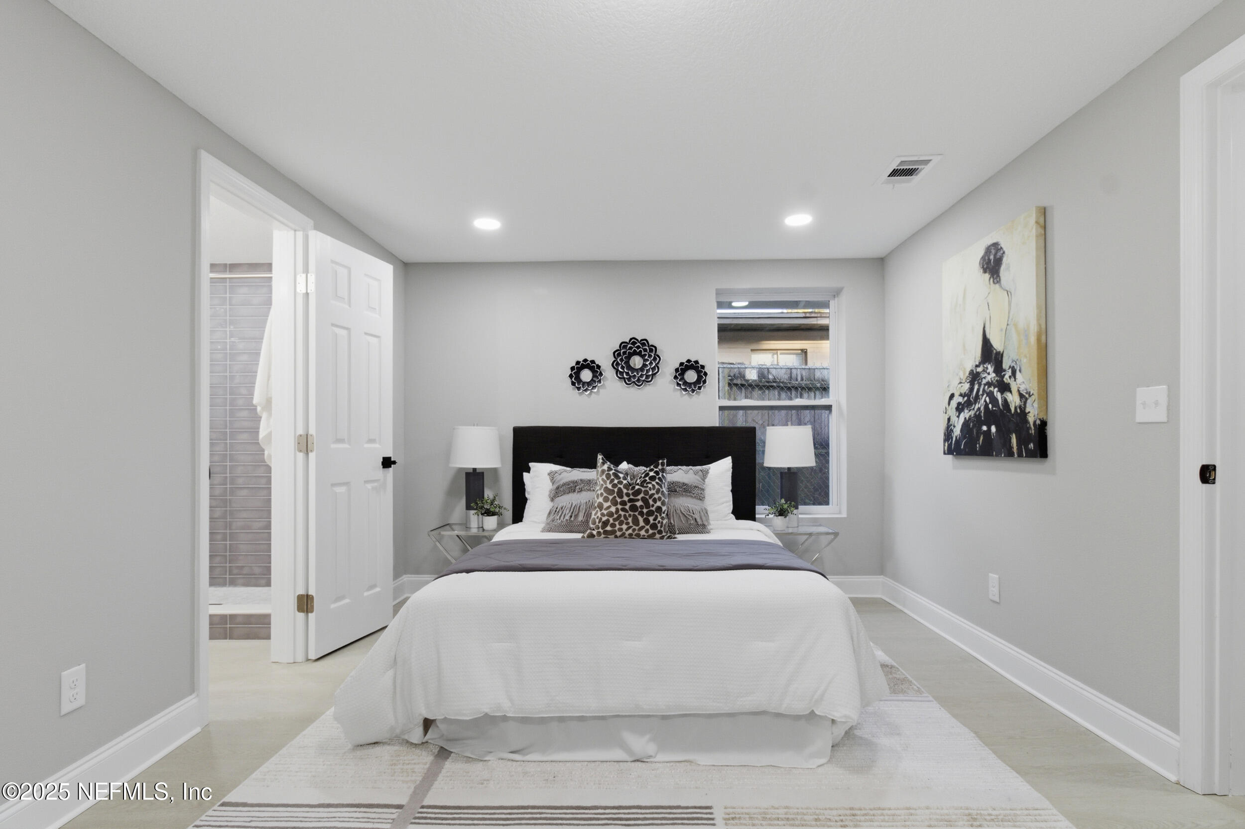 5475 Gable Lane Jacksonville, FL 32211 - Photo 13 of 36 a bedroom with a large bed and a chandelier