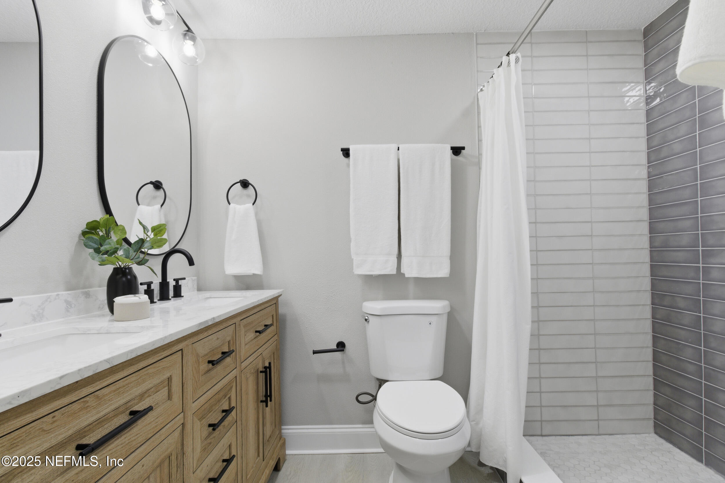 5475 Gable Lane Jacksonville, FL 32211 - Photo 18 of 36 a bathroom with a granite countertop toilet sink and mirror