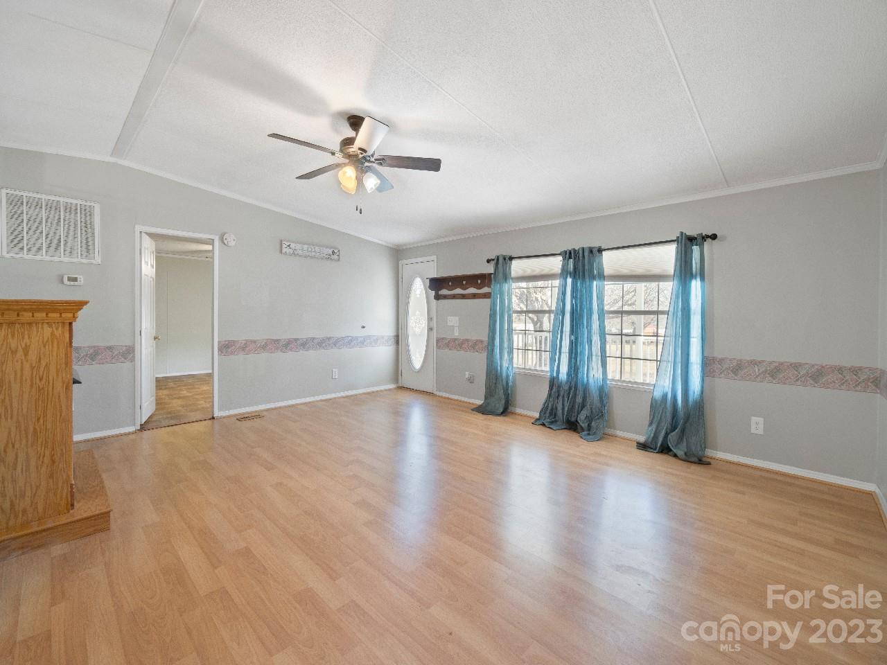 6580 Houser Farm Road Vale, NC 28168 - Photo 7 of 36 a view of an empty room with a window and wooden floor