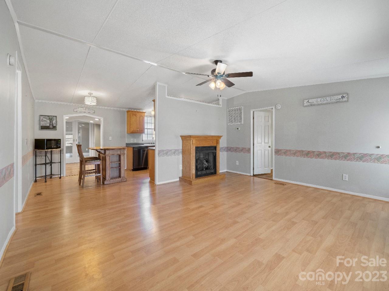 6580 Houser Farm Road Vale, NC 28168 - Photo 8 of 36 a view of empty room with wooden floor and fireplace
