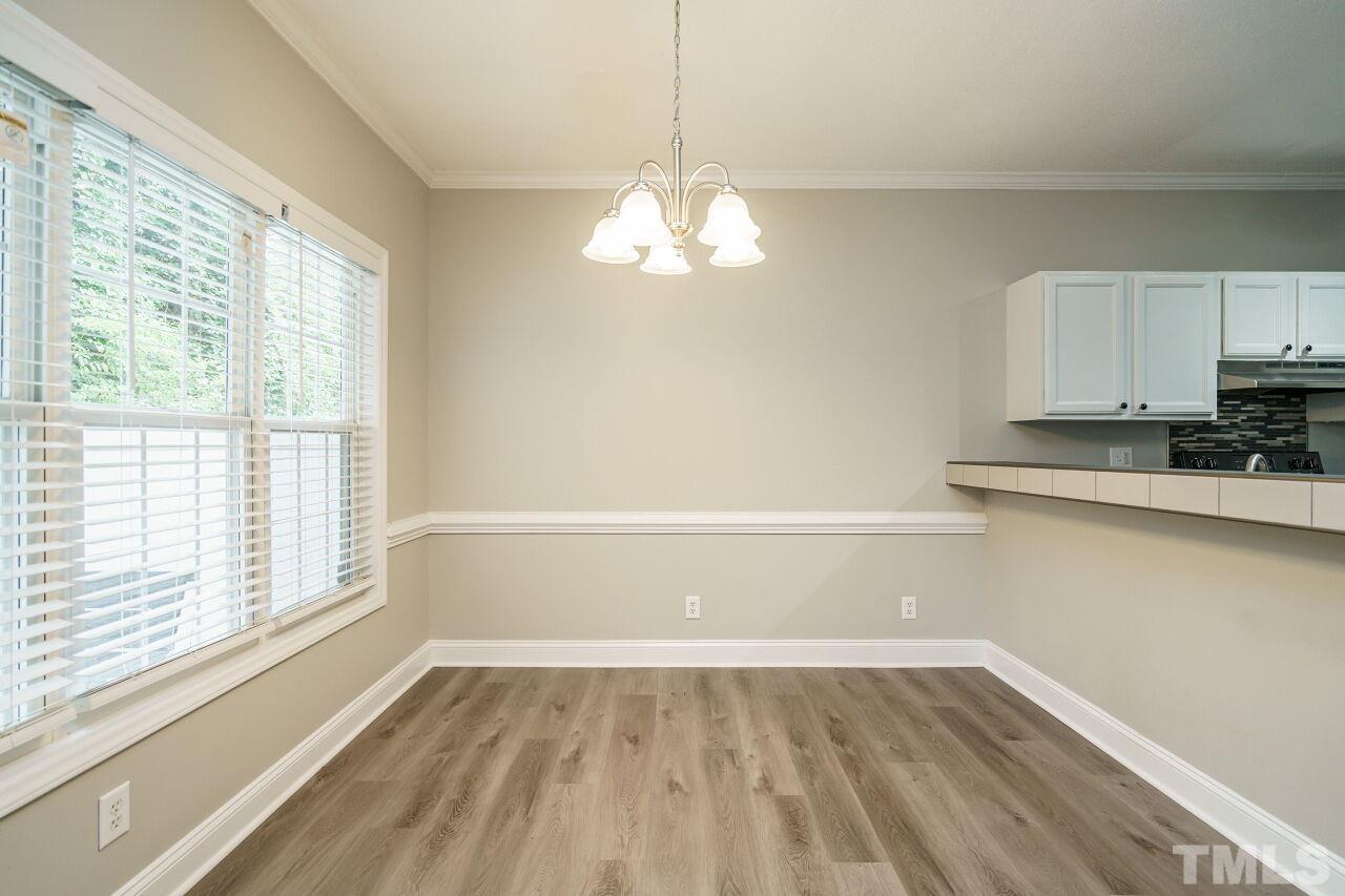 4509 Pinckney Place Raleigh, NC 27604 - Photo 11 of 28 a view of a room with wooden floor and a window
