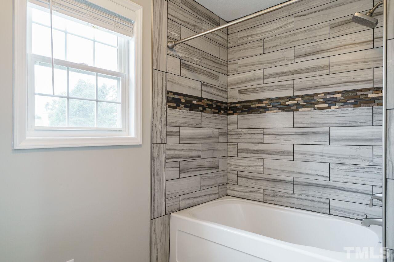 4509 Pinckney Place Raleigh, NC 27604 - Photo 21 of 28 a bathroom with a bathtub and shower