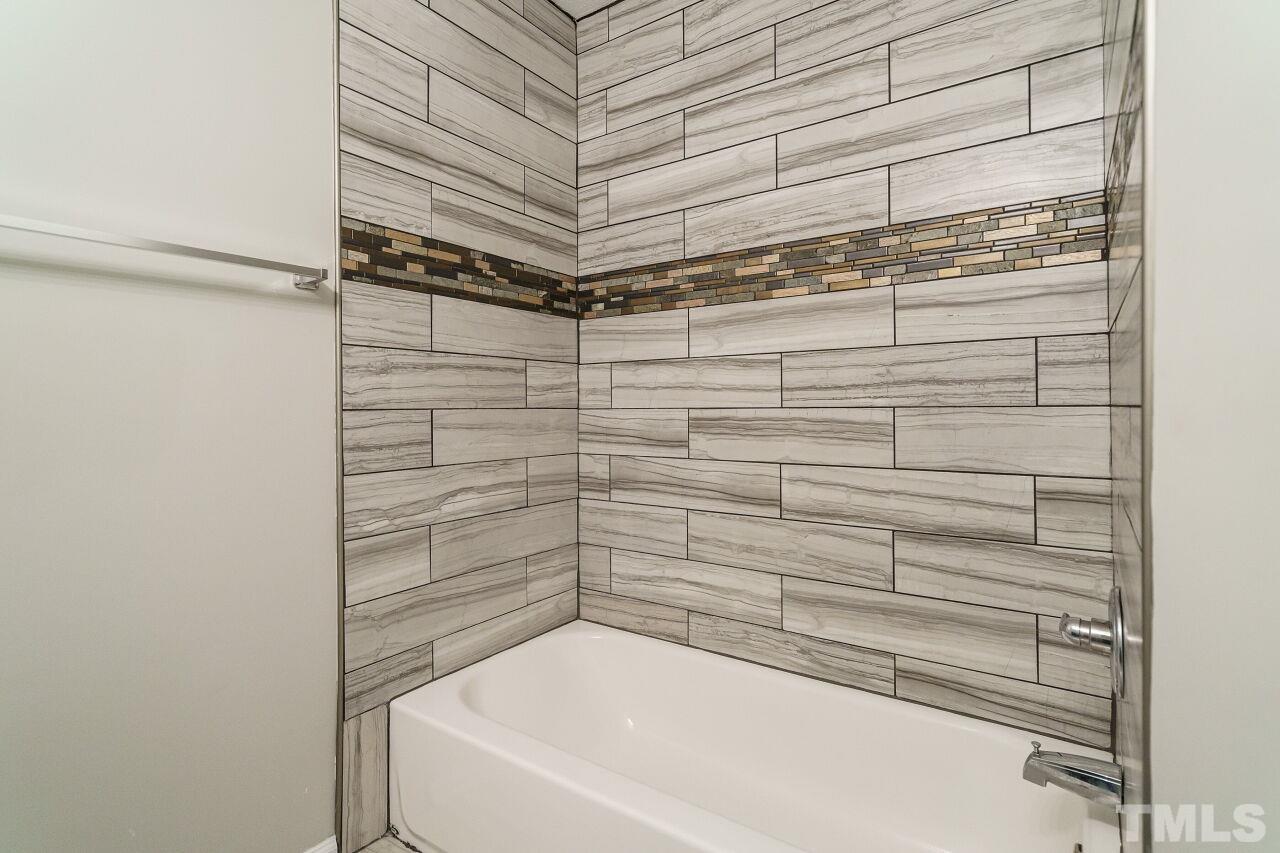 4509 Pinckney Place Raleigh, NC 27604 - Photo 25 of 28 a bathroom with a bathtub and shower