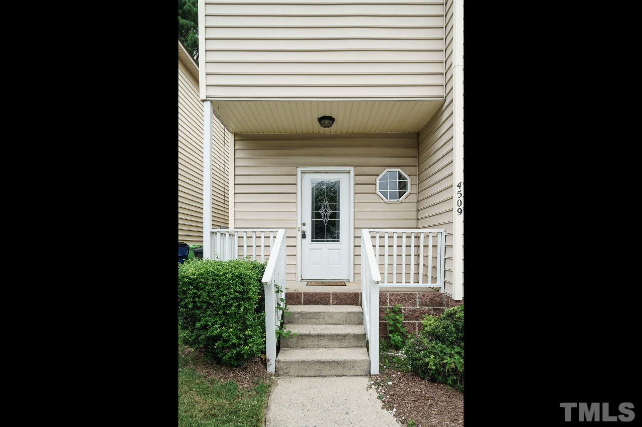 4509 Pinckney Place Raleigh, NC 27604 - Photo 3 of 28 a view of a porch with wooden floor and a window