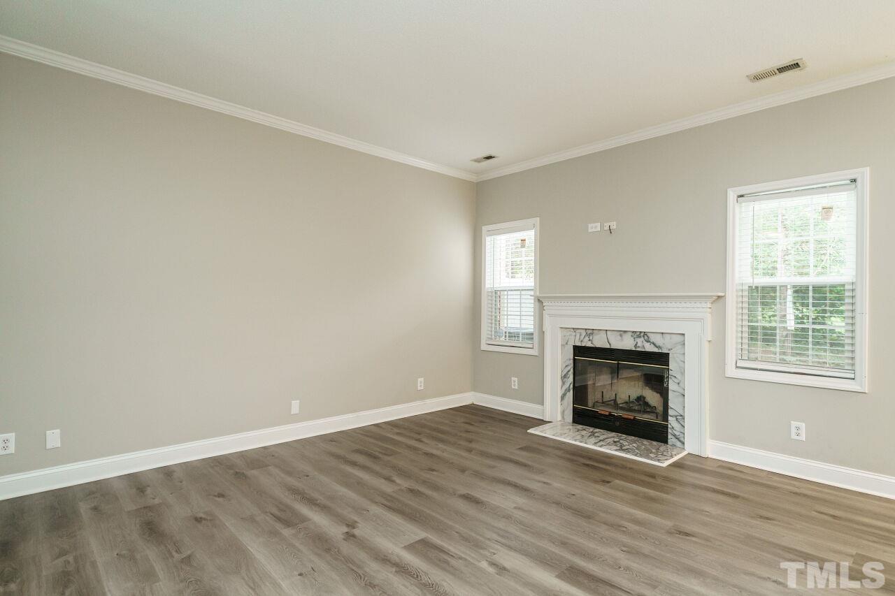 4509 Pinckney Place Raleigh, NC 27604 - Photo 5 of 28 a view of an empty room with a window and fireplace