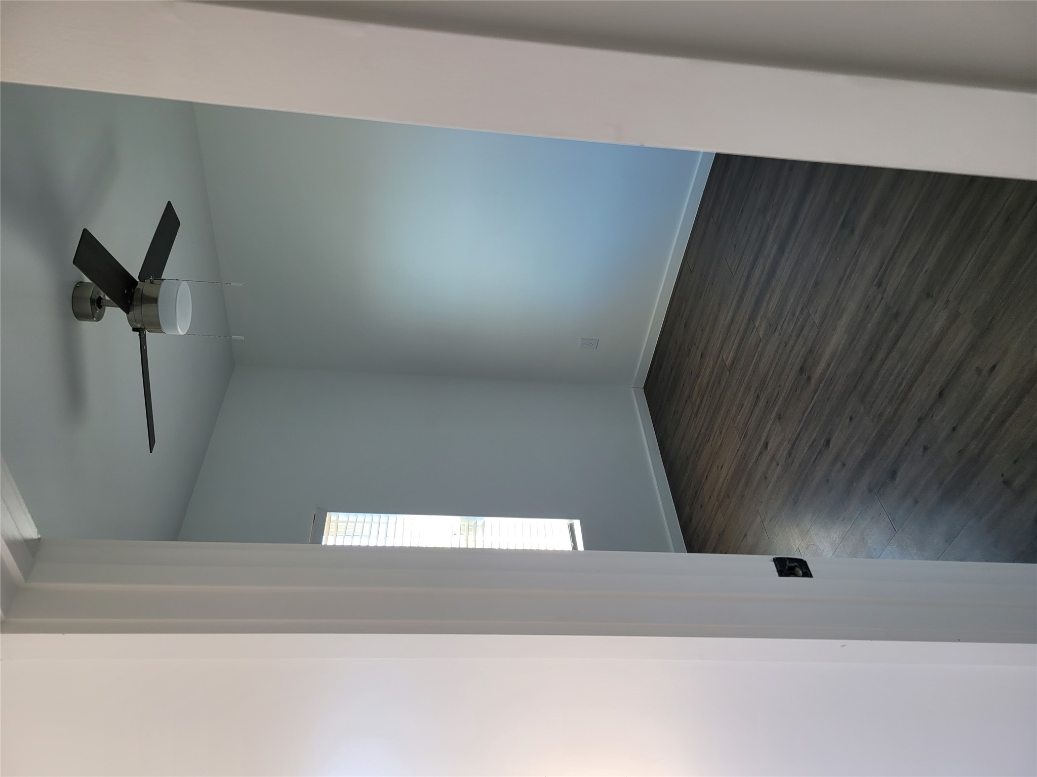 422 A Road Stockdale, TX 78160 - Photo 21 of 40 An inviting room features dark plank flooring, light walls, and a contemporary ceiling fan.