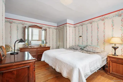 a bedroom with a large bed and a dresser