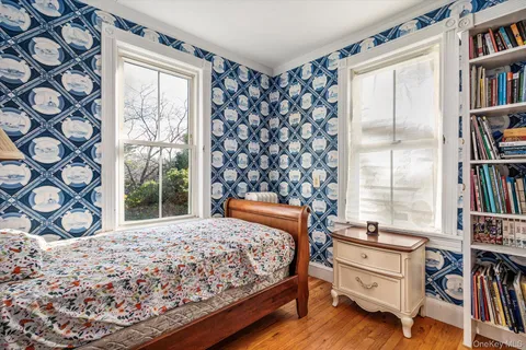 a bedroom with a bed and a book shelf