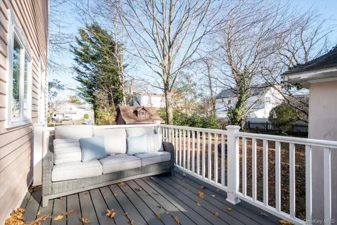 a view of balcony with wooden floor and outdoor seating