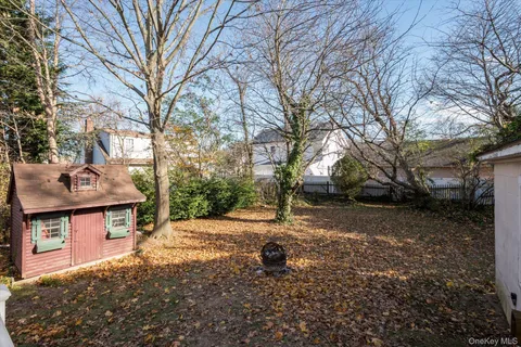 a view of a backyard with table and chairs and a fire pit