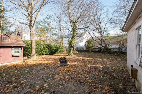a backyard of a house with barbeque oven table and chairs