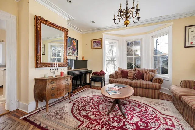 a living room with furniture a flat screen tv and a window