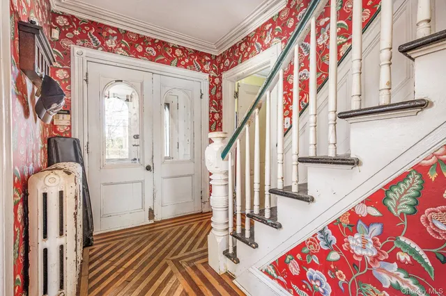 a view of an entryway with wooden floor and stairs