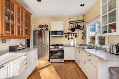 a kitchen with stainless steel appliances granite countertop a refrigerator and a stove