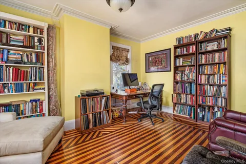 a reading room with furniture book shelf and a book shelf