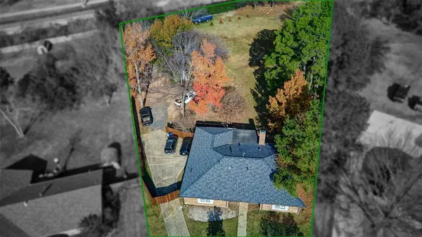 an aerial view of a house with garden space and sitting area