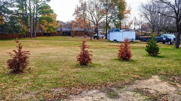 a view of a yard with a house in the background
