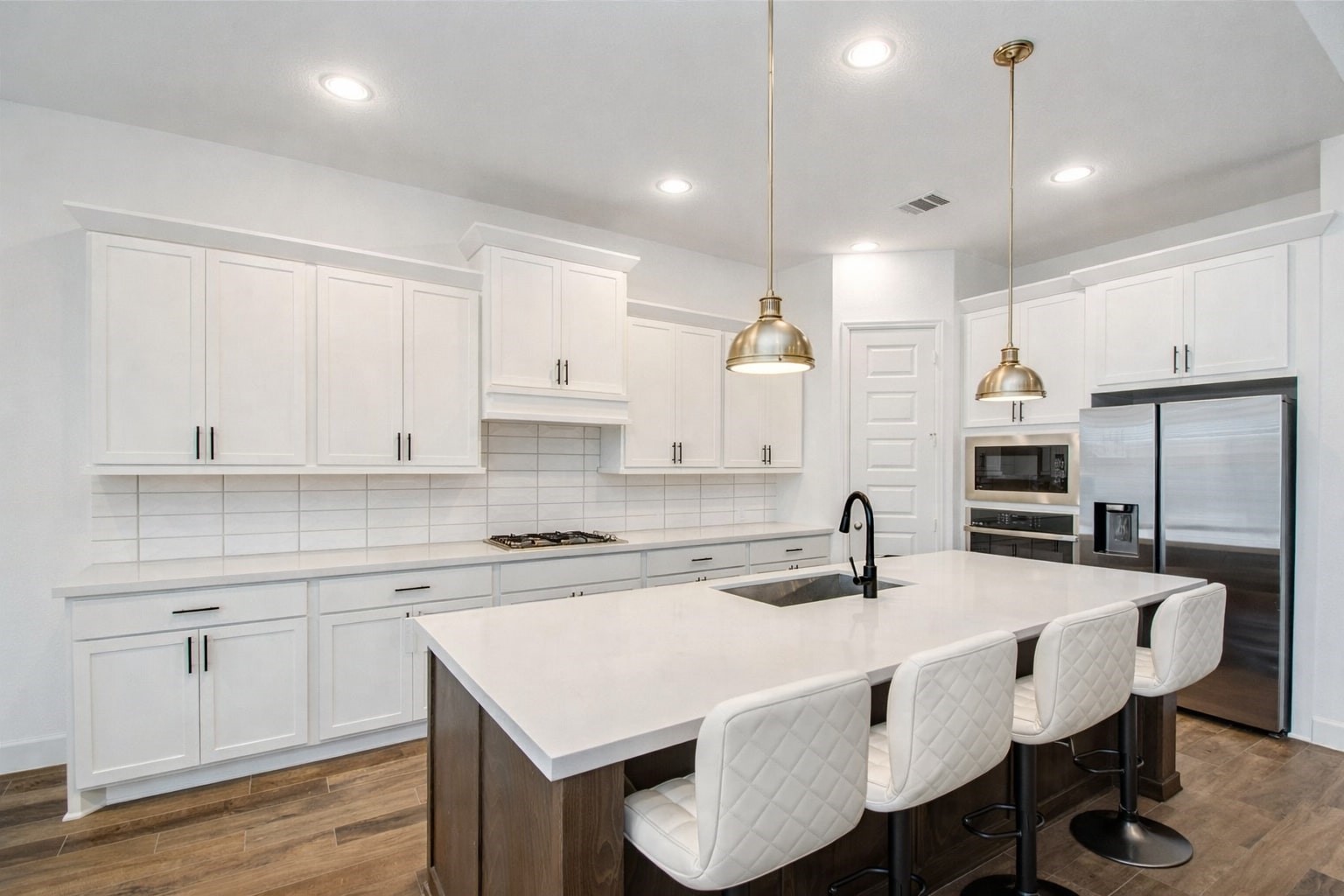 3011 Harbor Spring Way Manvel, TX 77578 - Photo 12 of 29 a kitchen with kitchen island a sink table and chairs