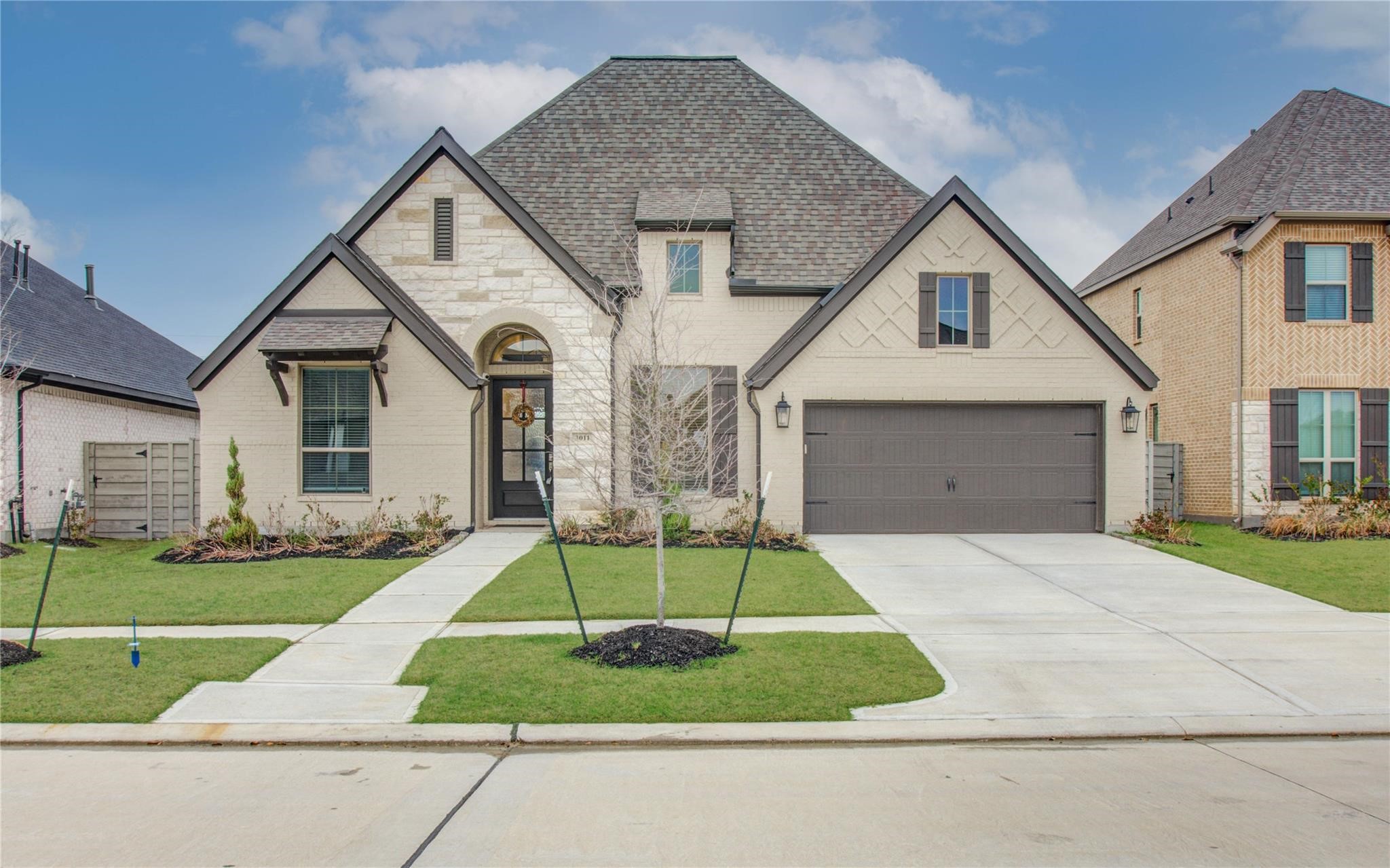 3011 Harbor Spring Way Manvel, TX 77578 - Photo 2 of 29 a front view of a house with a yard and garage