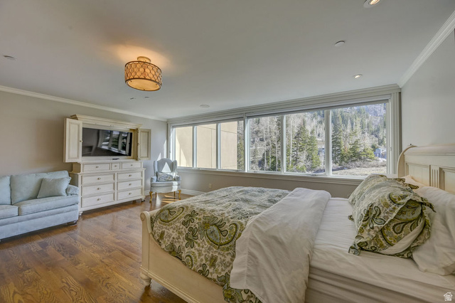 9699 Bypass Road, Unit 5 Alta, UT 84092 - Photo 35 of 54 Hardwood flooring enhances this bedroom featuring a large picture window overlooking a wooded landscape