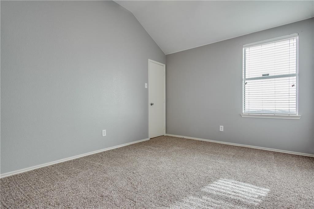 3608 Diamond Ranch Road Fort Worth, TX 76262 - Photo 8 of 13 Carpeted spare room featuring baseboards and lofted ceiling