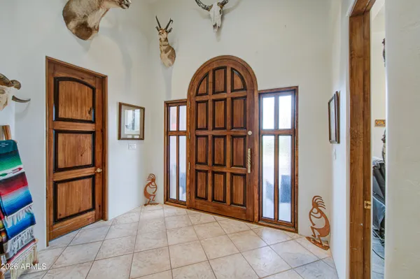 a large white kitchen with stainless steel appliances granite countertop a sink and dishwasher a refrigerator with wooden cabinets