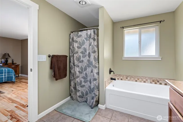 a bathroom with a bathtub and a shower