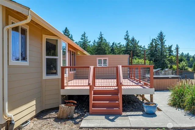 a view of a house with a balcony and trees