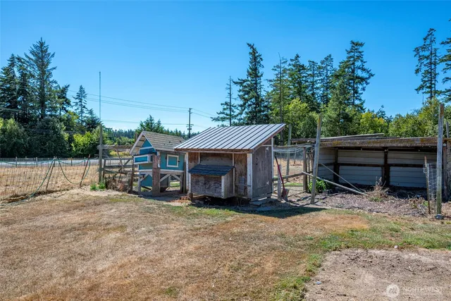 a view of house with backyard and seating area