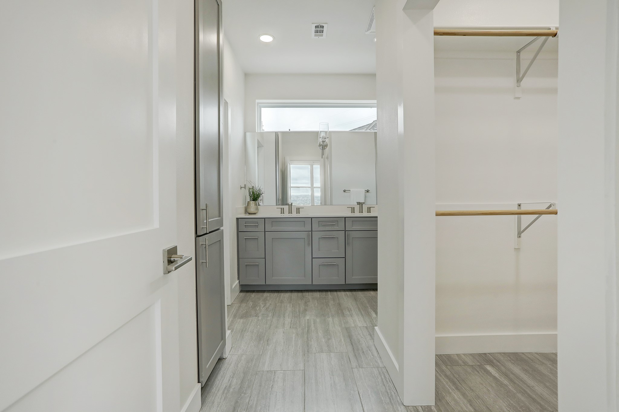 4300 Mansfield Dam Road, Unit 531 Austin, TX 78734 - Photo 20 of 32 Sleek tile floors lead to a modern double vanity and an adjoining closet space.