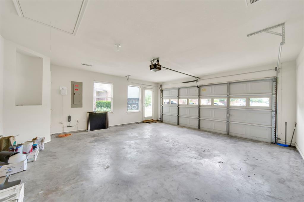 4221 Fiste Denton, TX 76207 - Photo 23 of 26 Garage featuring a garage door opener and electric panel