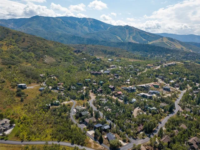a view of a houses with a lush green hillside