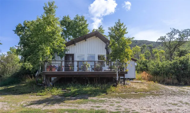 a view of a chair and table on the deck