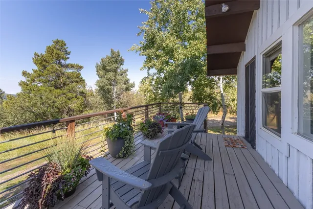 a view of a balcony with chair and wooden floor