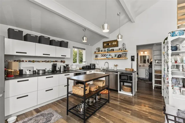 a kitchen with stainless steel appliances a stove a refrigerator and cabinets