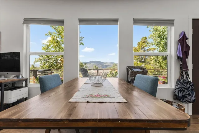 a view of a workspace with furniture and a window