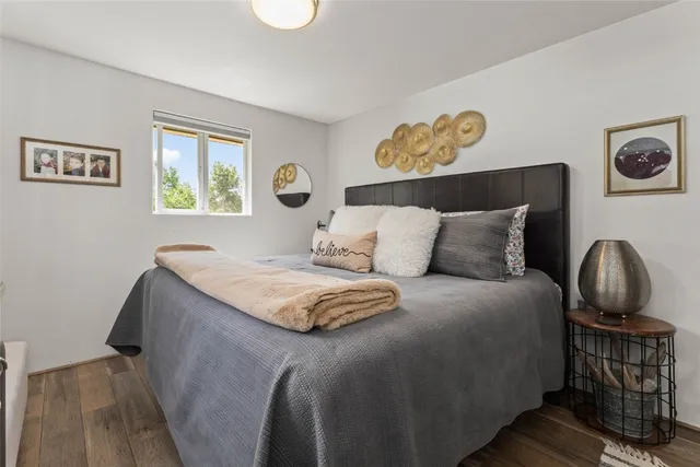 a bedroom with a bed and a painting on the wall