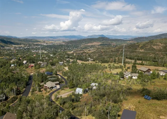 an aerial view of residential houses with city view